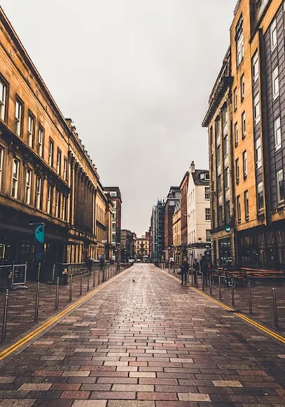 City street lined with limestone and sandstone buildings