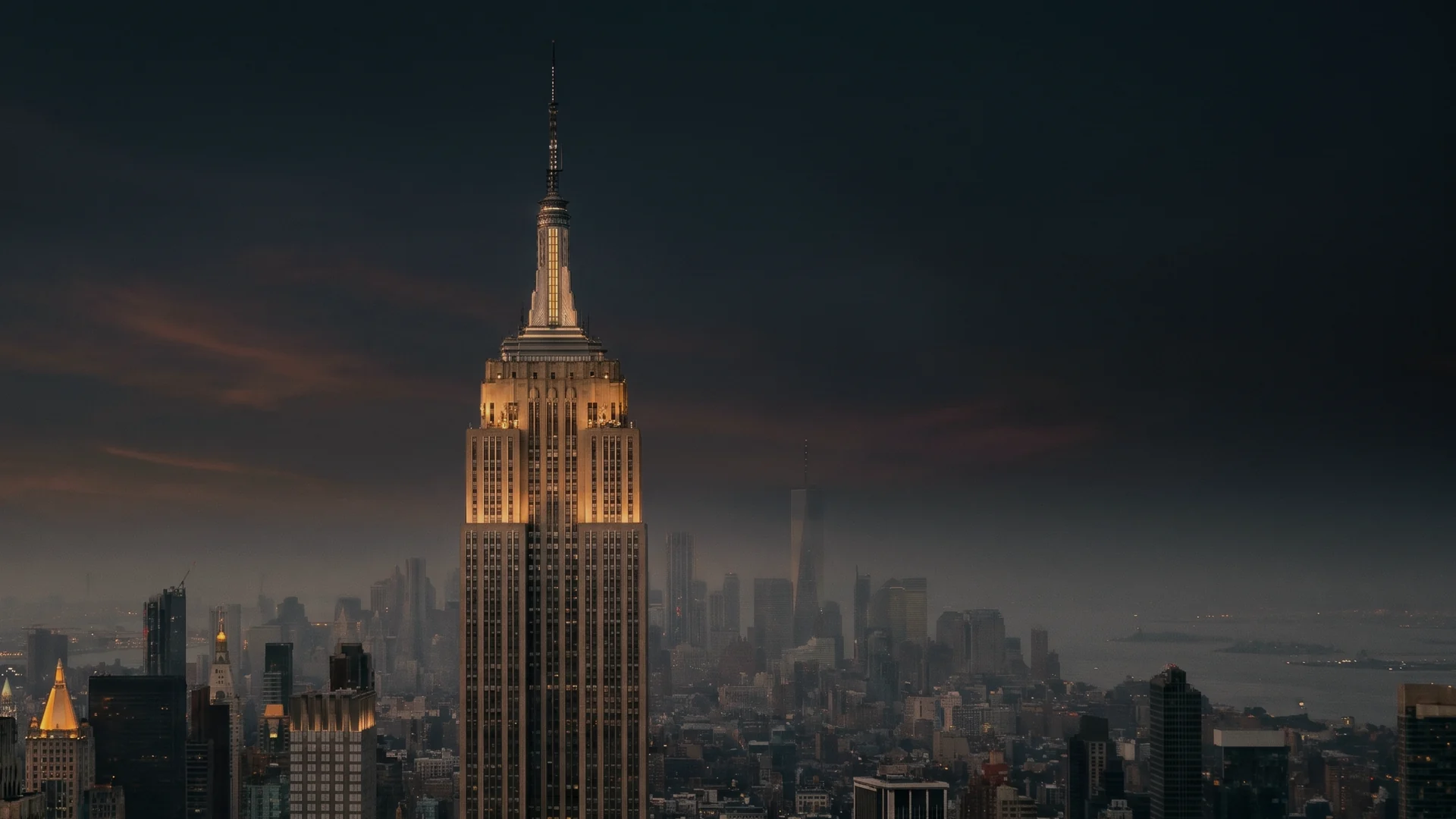 The Empire State Building at dusk, its Indiana limestone crown lit, over Midtown Manhattan