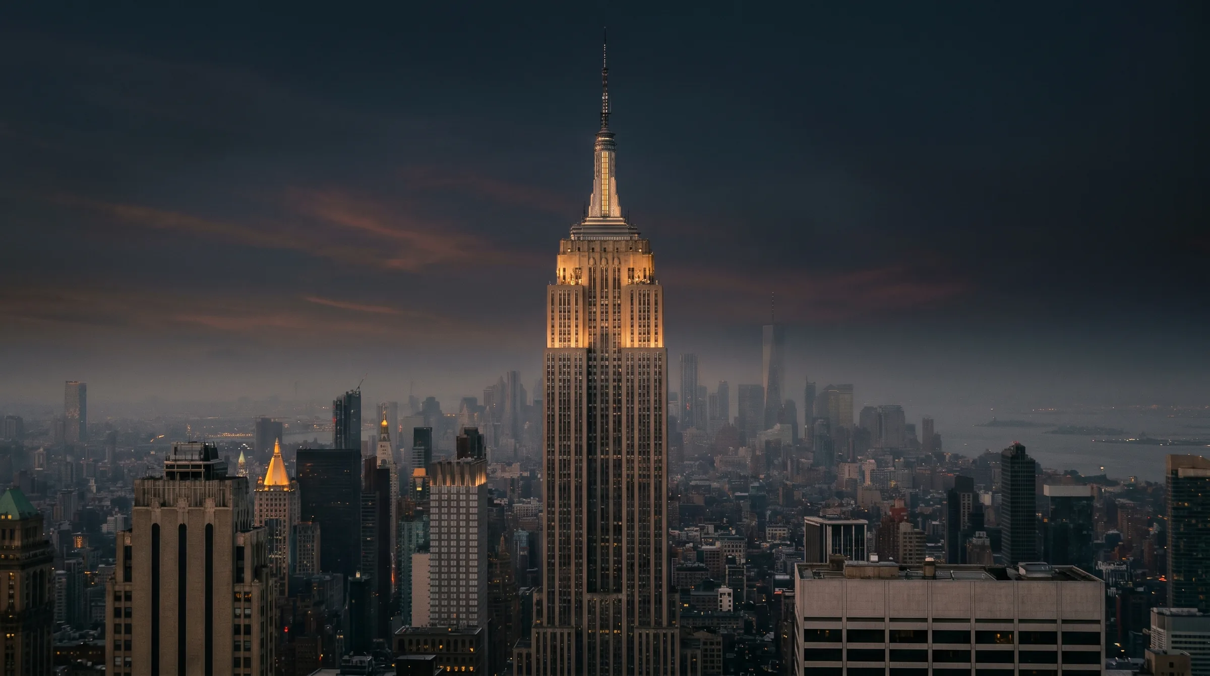 The Empire State Building at dusk, faced in Indiana limestone, above Midtown Manhattan