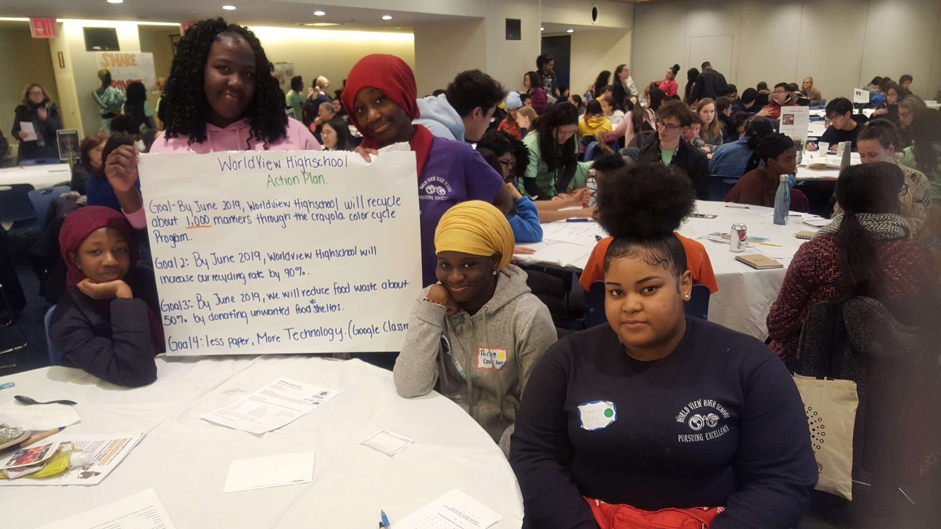 WorldView High School students presenting sustainability action plan poster