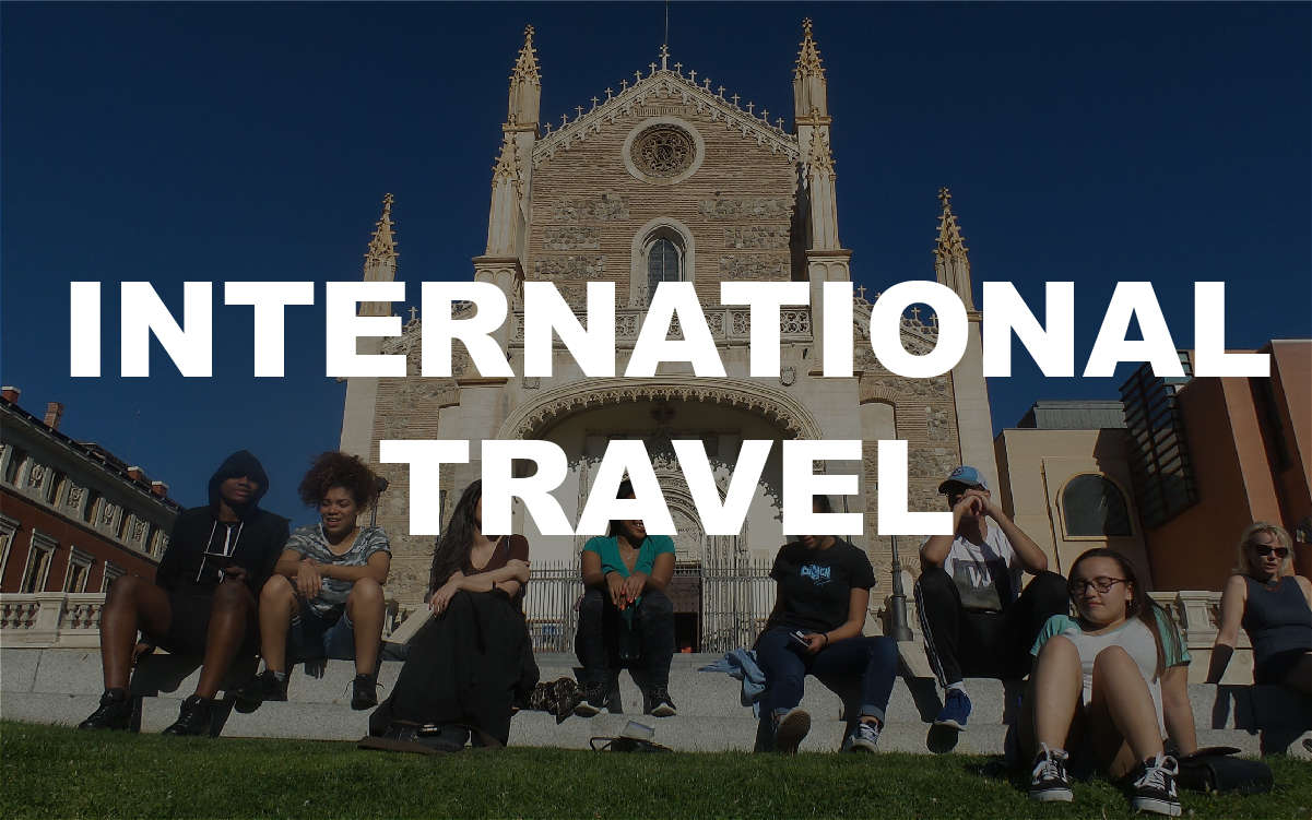 Students sitting outside a historic European cathedral during international travel
