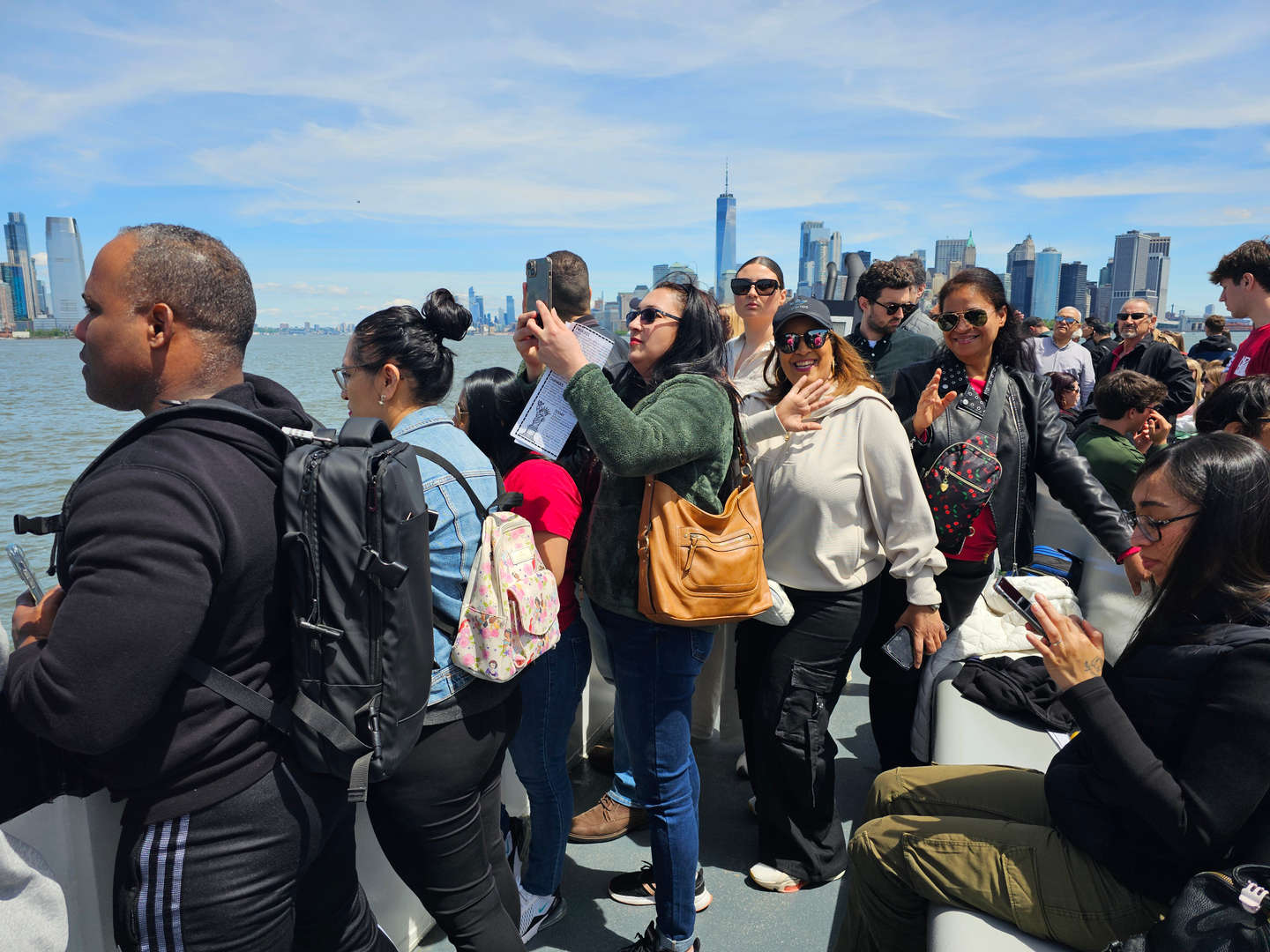 Students and parents on a ferry boat with New York City skyline