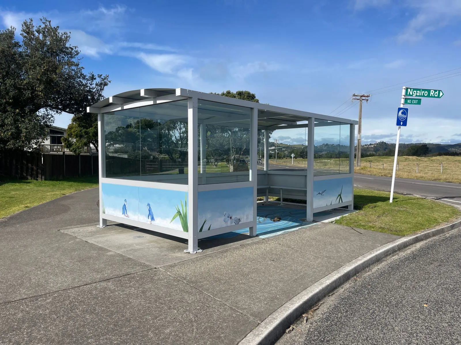 Glass bus shelter with illustrated community artwork panels