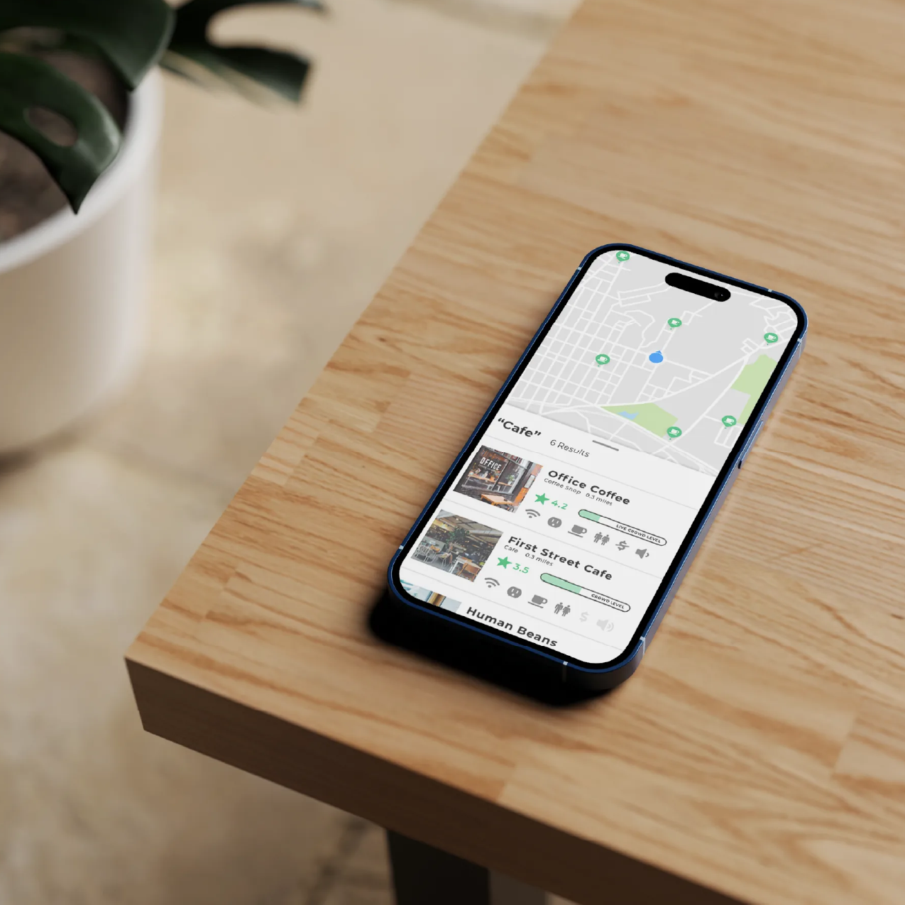 An iPhone sitting on the corner of a wooden table showing a map with search results for a cafe with ratings and other information.