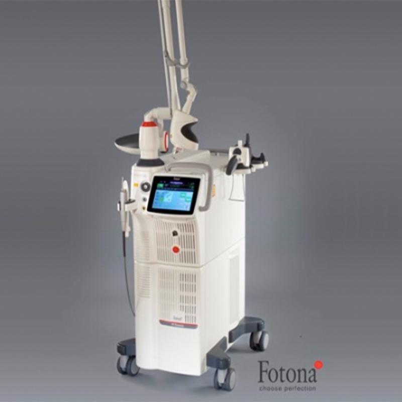 Fotona medical laser machine with touchscreen and articulated arm on wheels against gray background.