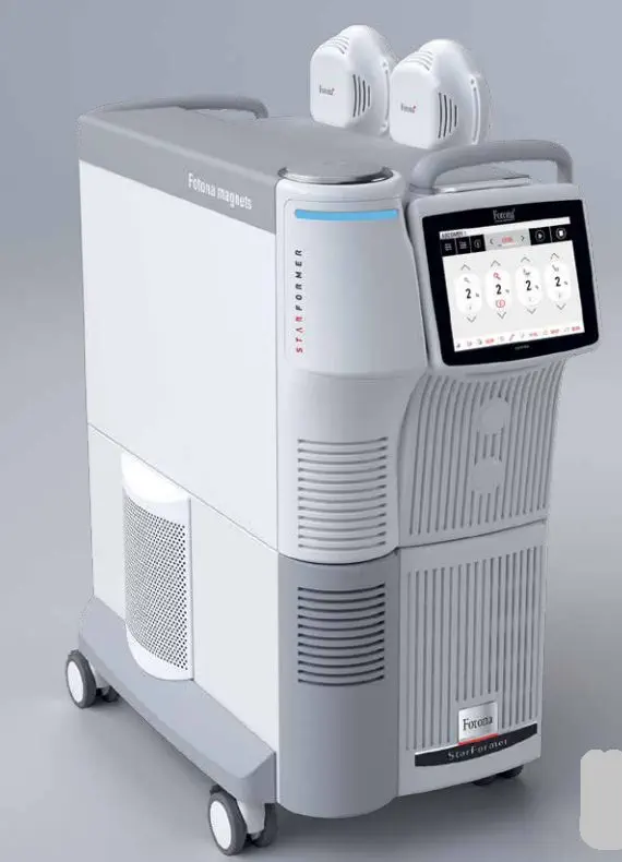 White and gray StarFormer medical device with touchscreen and two applicators on top, on wheels.