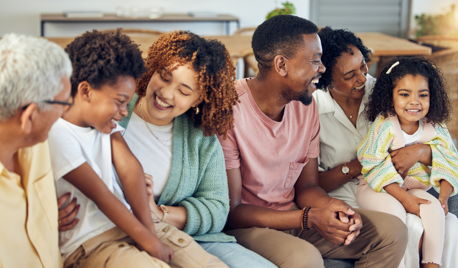 Family sitting on couch stock image