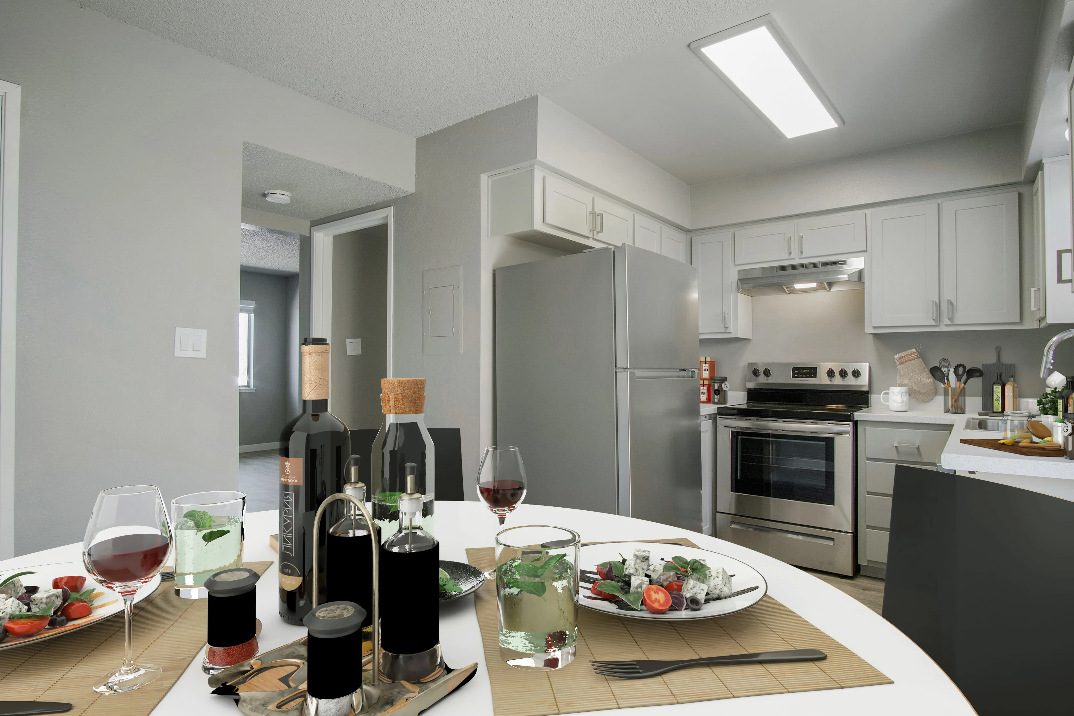 Kitchen with stainless steel appliances and virtually staged dining area with table, chairs, and food