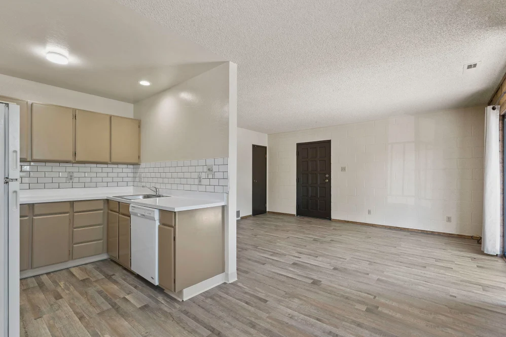 Unfurnished living area with view of kitchen