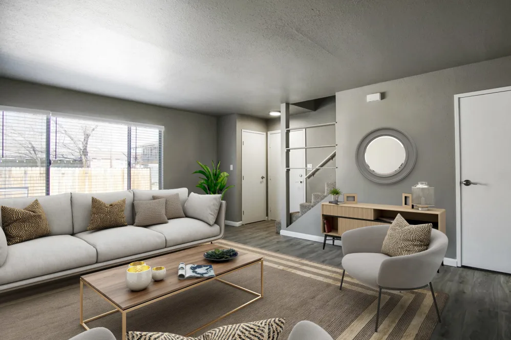Virtually furnished living area with sofa, coffee table and view of kitchen