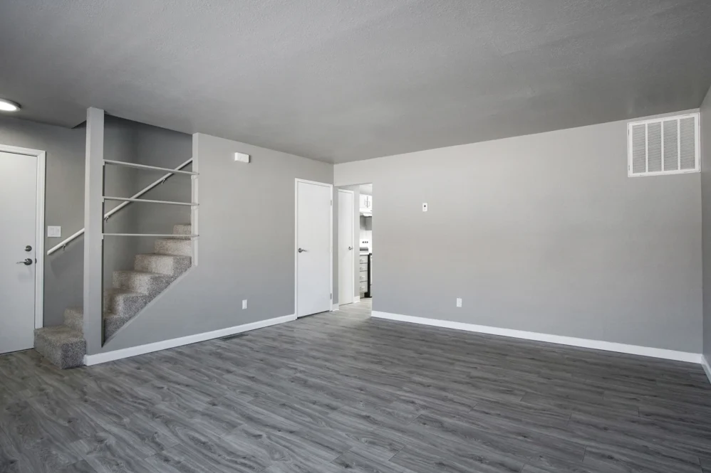 Unfurnished living area with view of stair case
