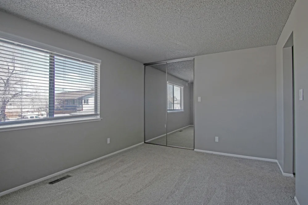 Unfurnished bedroom with carpet and large window