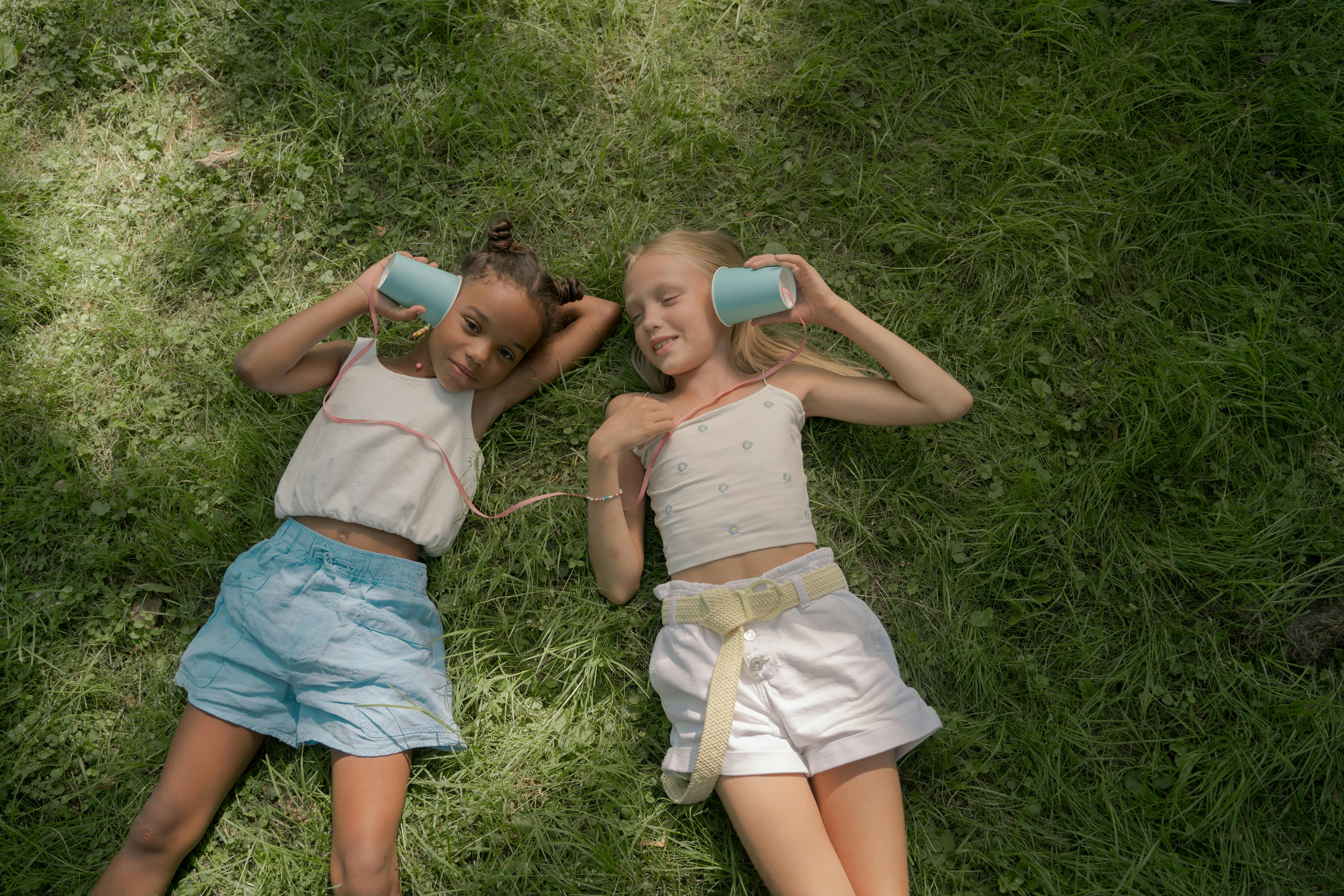 Kids sitting on grass stock image