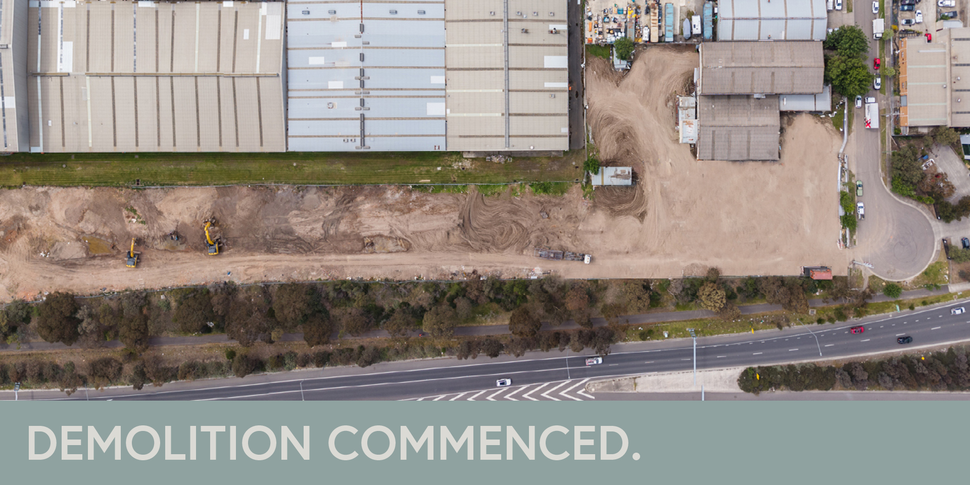 Aerial view of construction site with cleared land. "Demolition commenced."