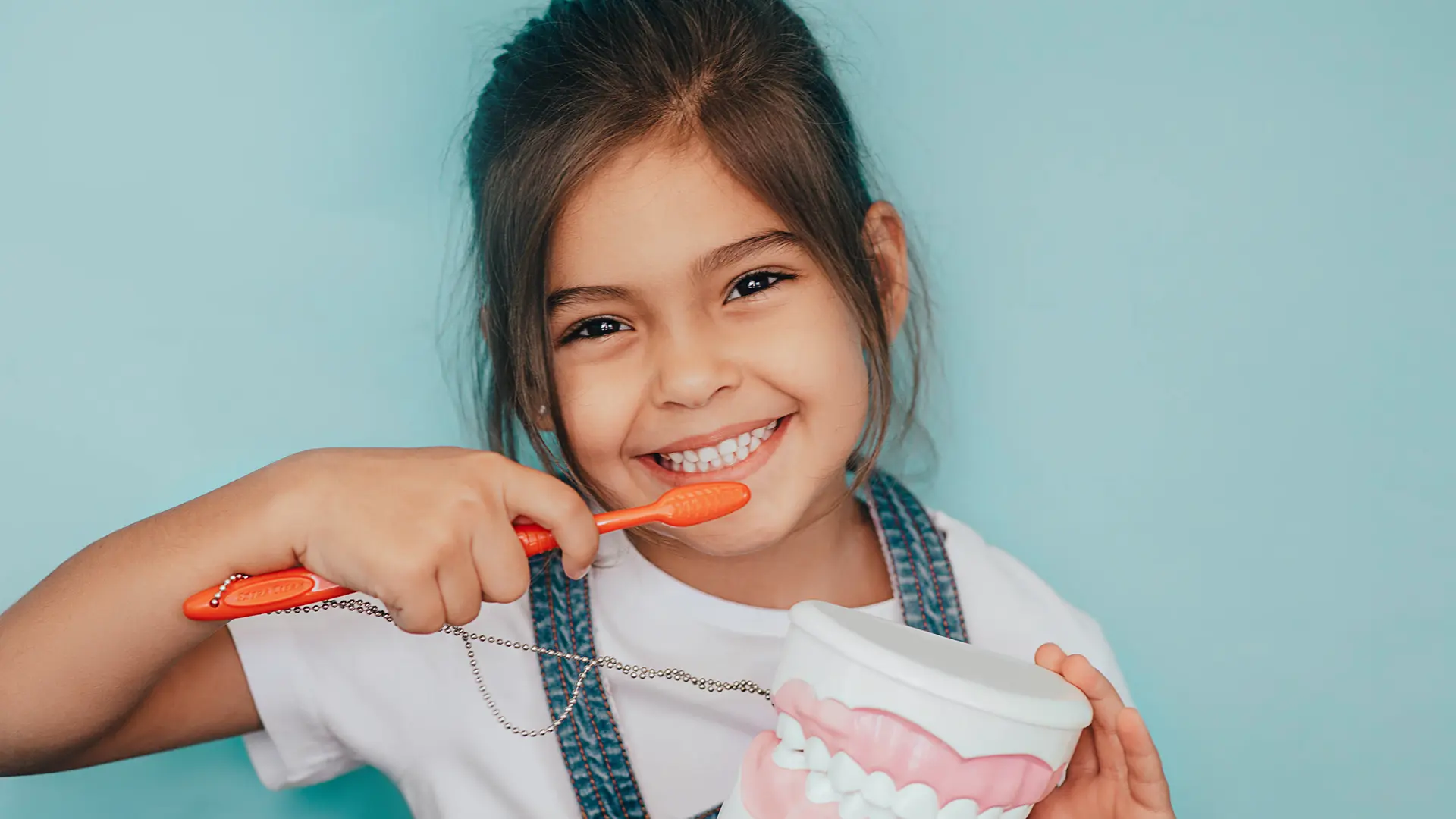 child holding a tooth brush