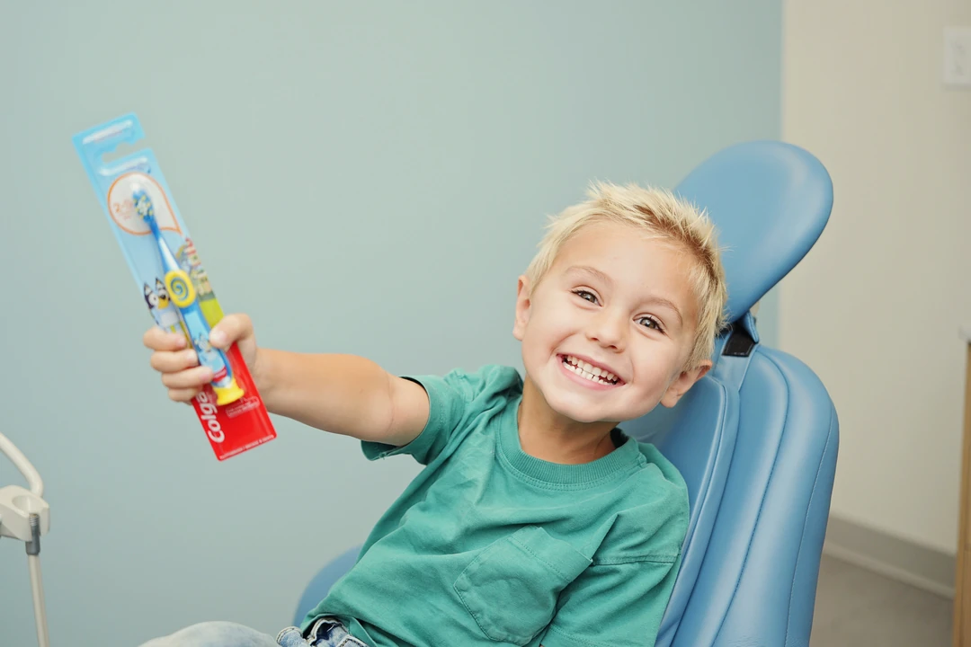 child holding a tooth brush