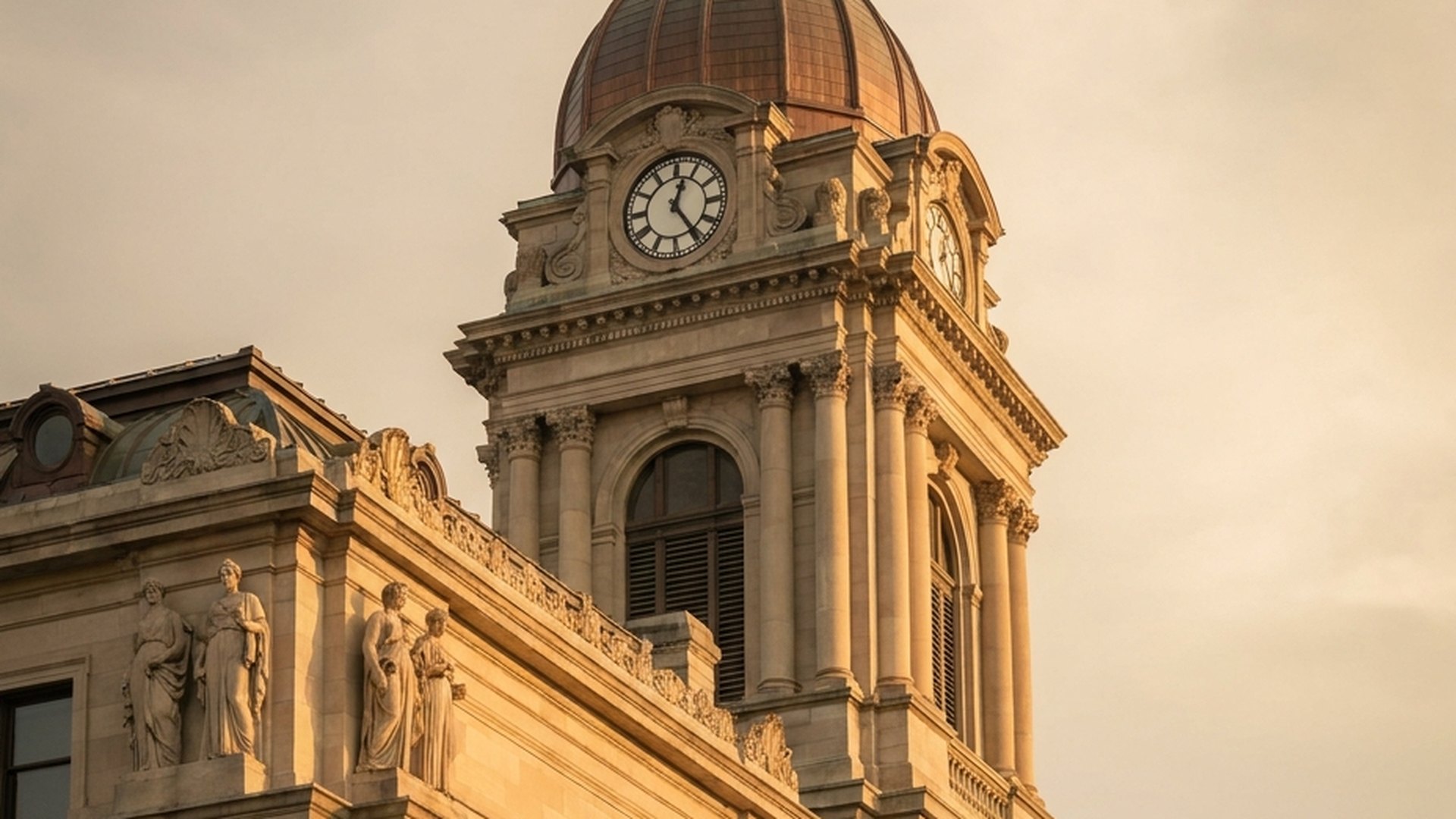 An Indiana limestone county courthouse, shot from below against an evening sky