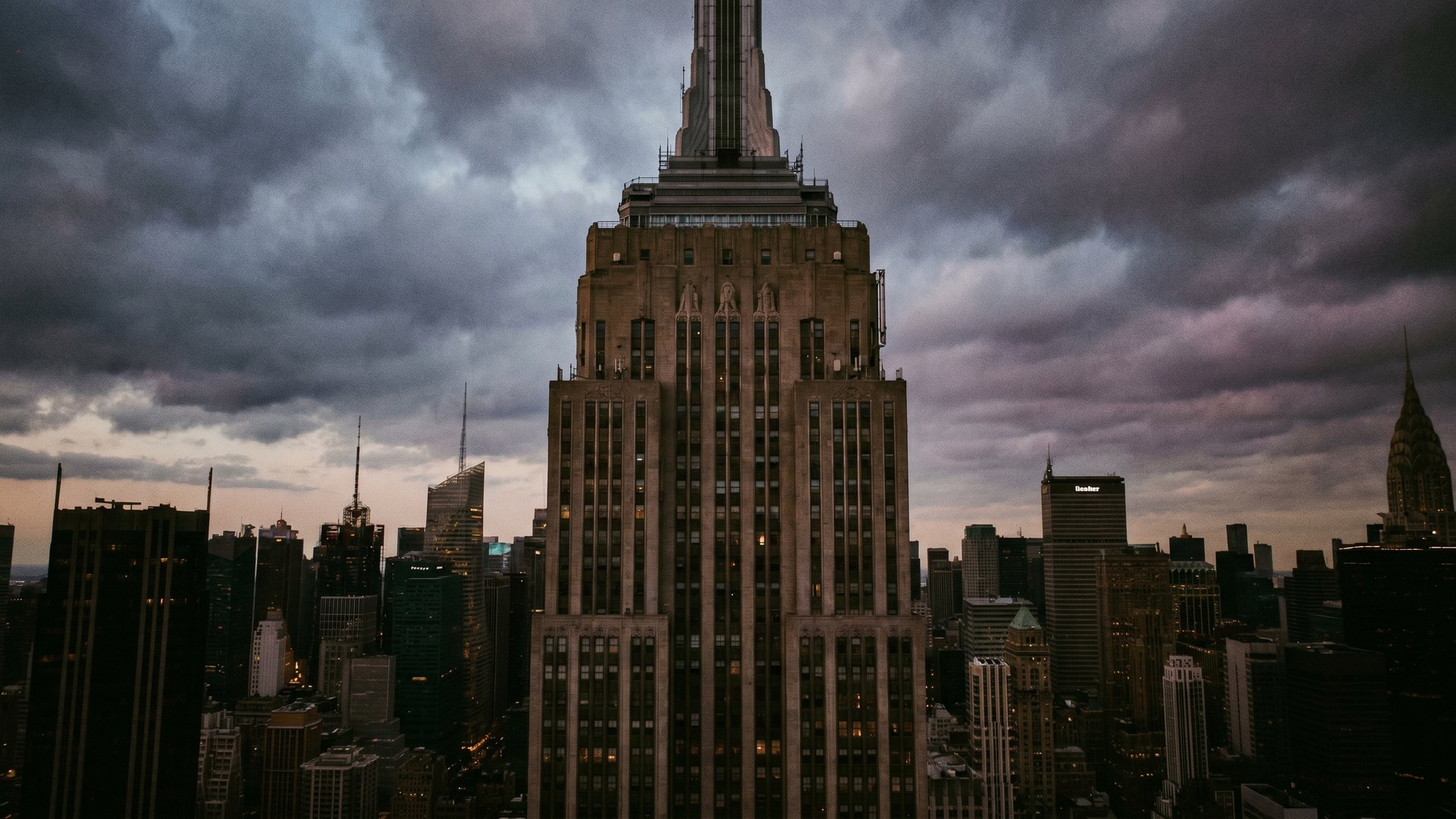The Empire State Building rising above the Manhattan skyline at dusk
