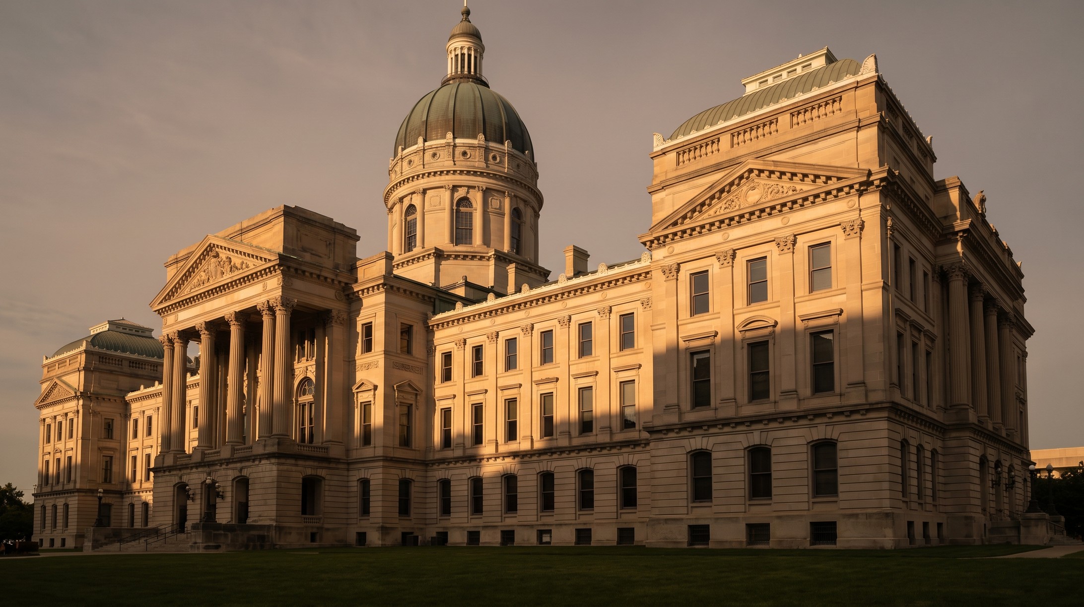 The Indiana Statehouse in Indianapolis, an 1888 Renaissance Revival capitol built of Indiana limestone, photographed in late afternoon light.