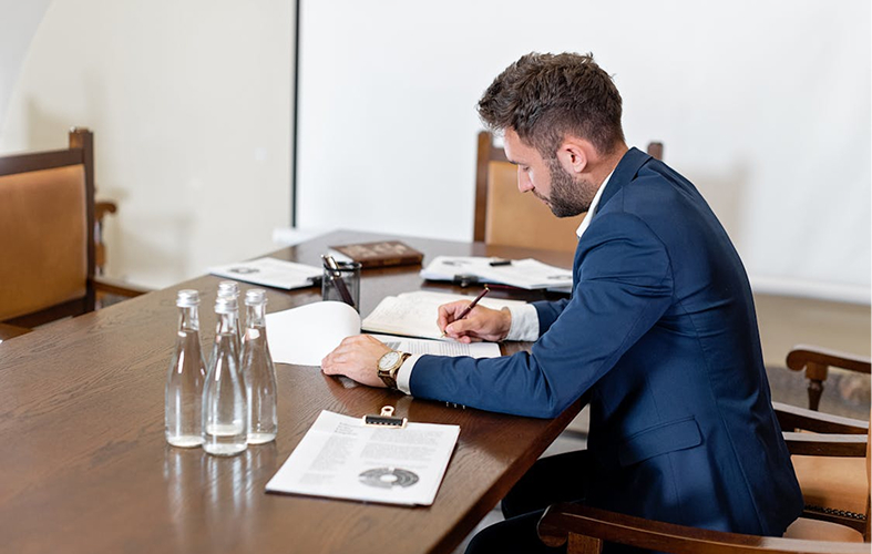 An advisor at a conference table working through a client's documents.
