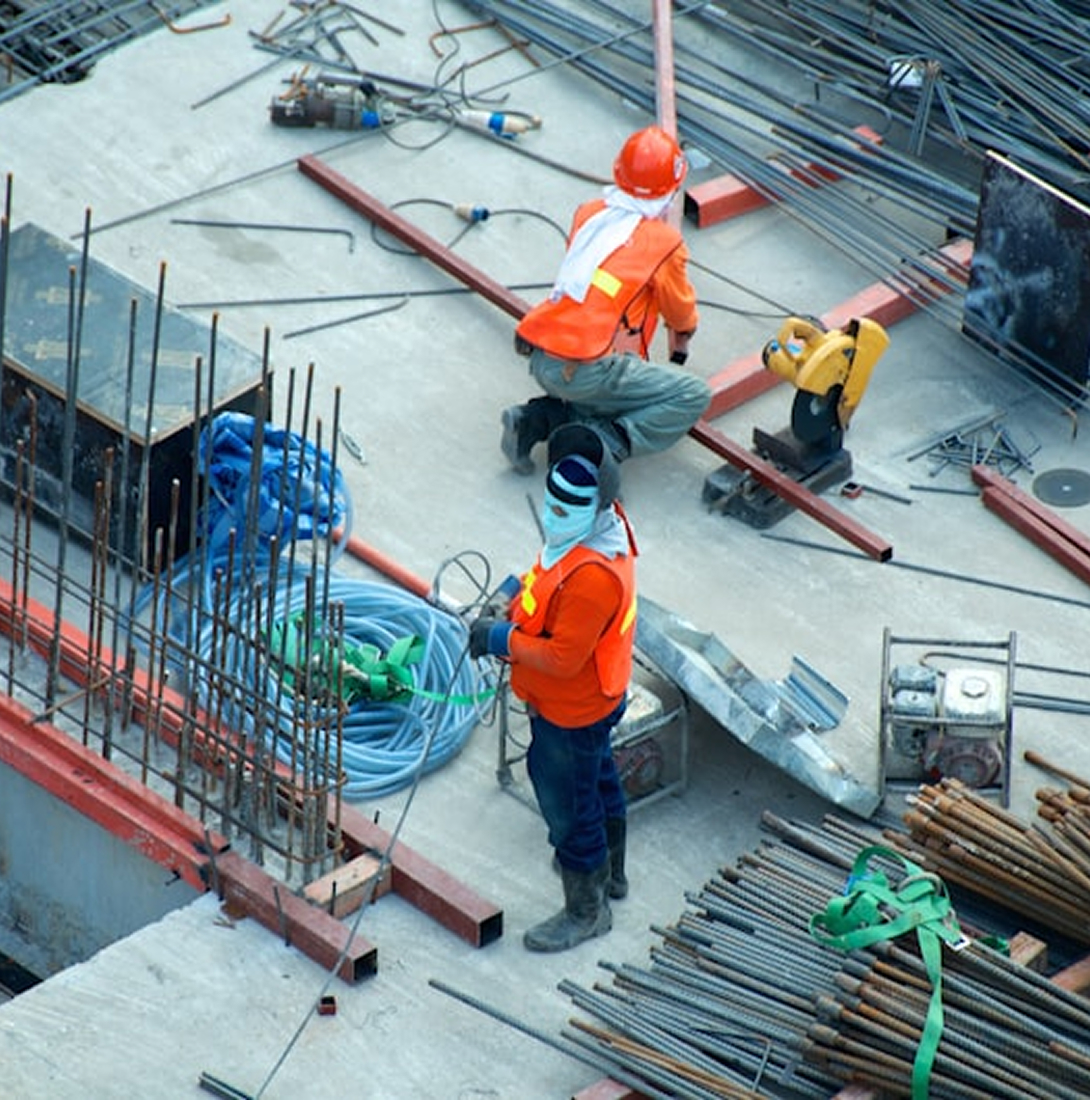 Aerial view of construction workers tying rebar on a job site