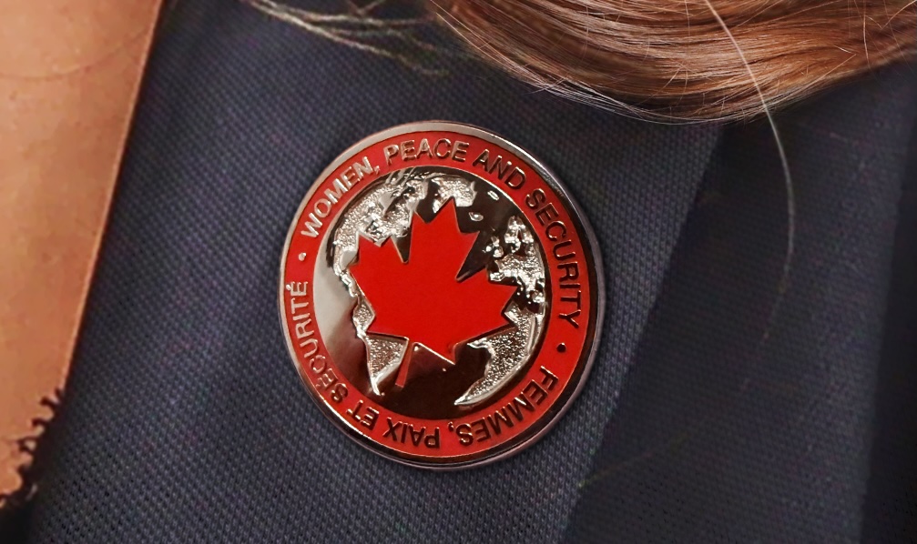 Pin for the Government of Canada's  Women Peace and Security Conference. Pinned to a Woman's lapel.