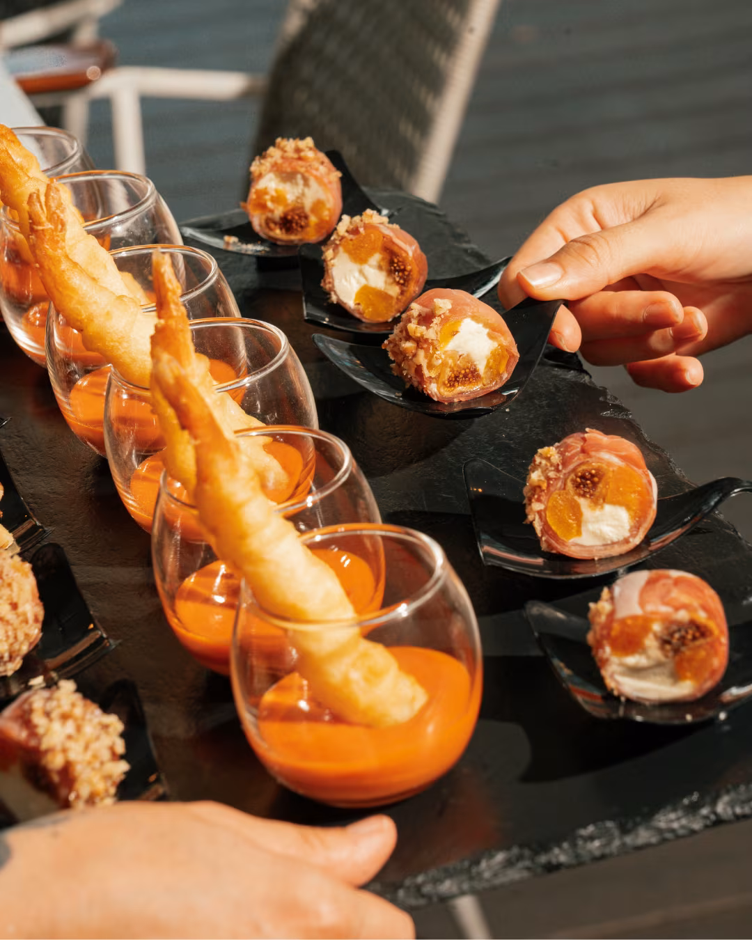 Canapes served at a La Mesa event, prosciutto wrapped figs and tempura prawns with romesco sauce