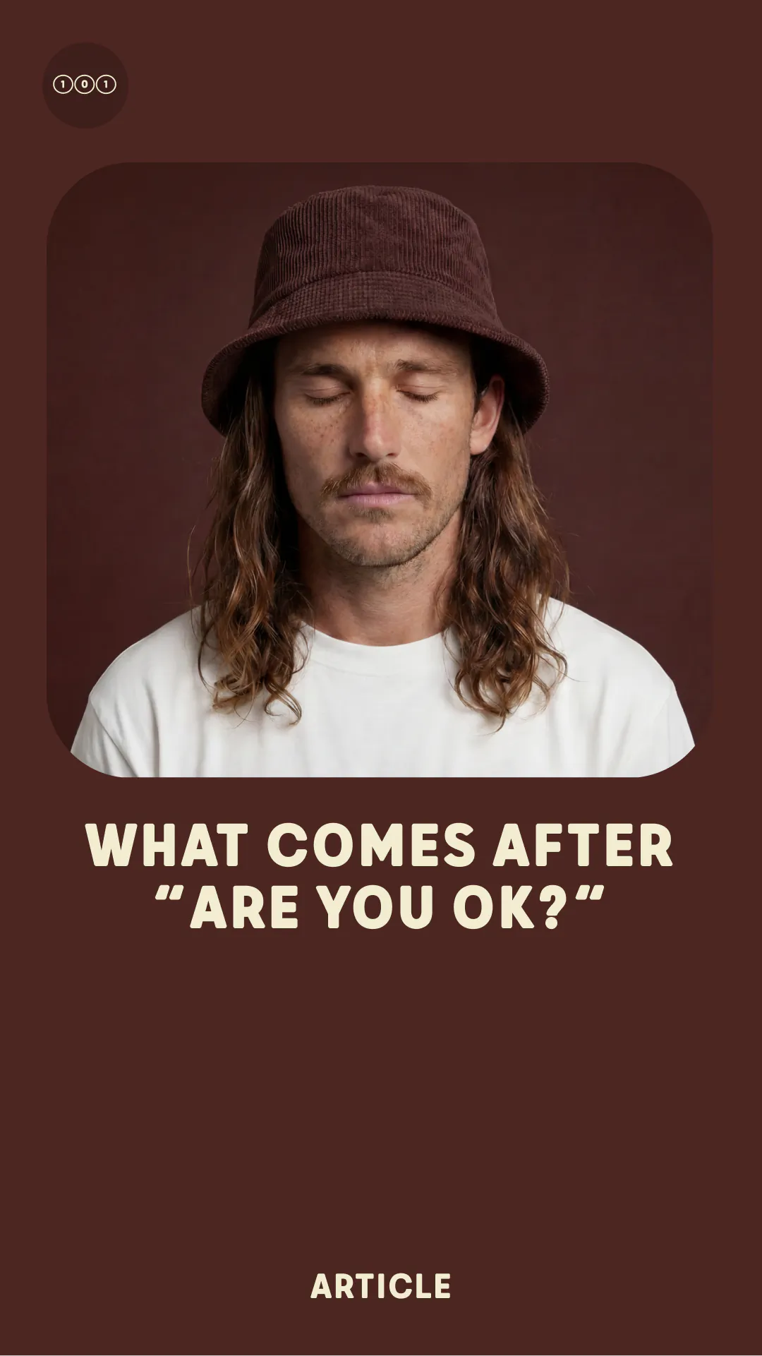 Man with long hair and mustache wearing a brown hat and white shirt with eyes closed.