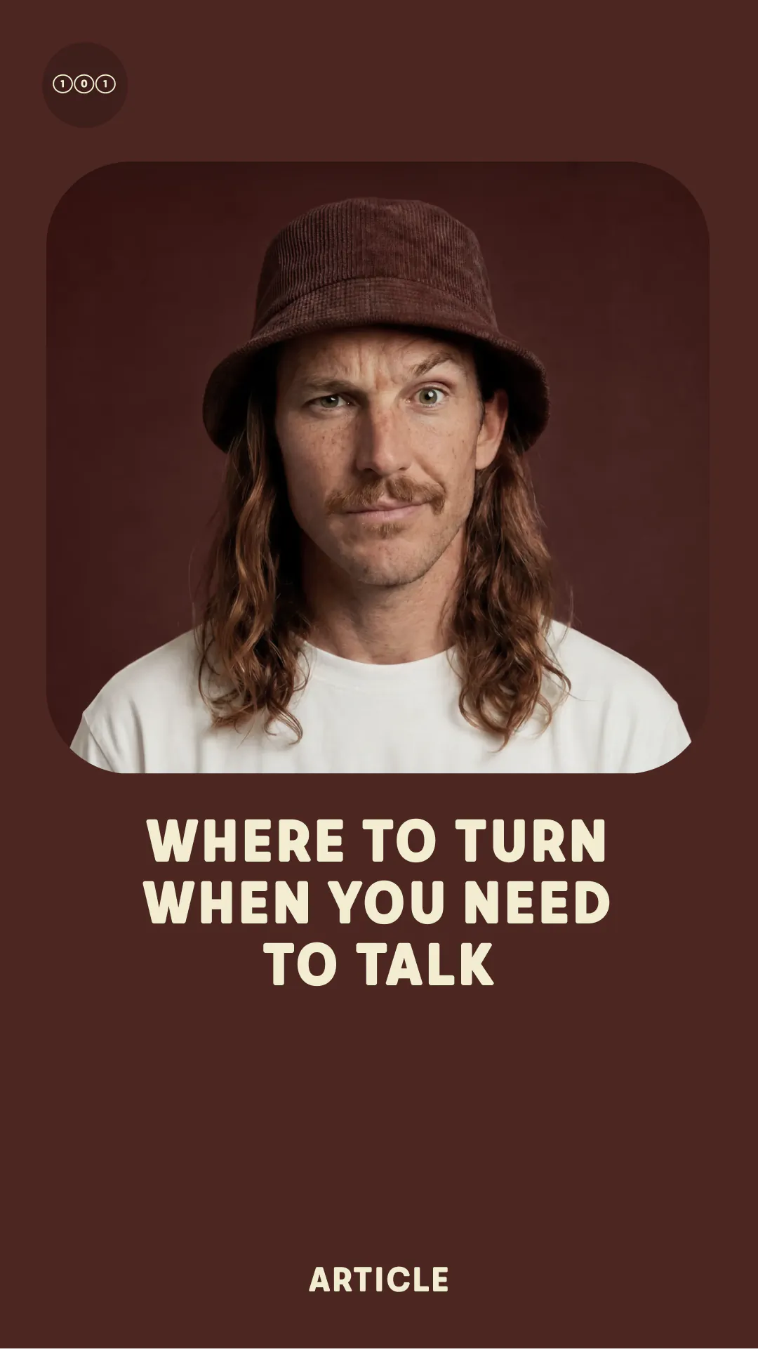Man with long hair and mustache wearing a brown hat and white shirt with eyes closed.