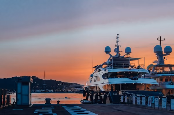 white boat docked on docking area