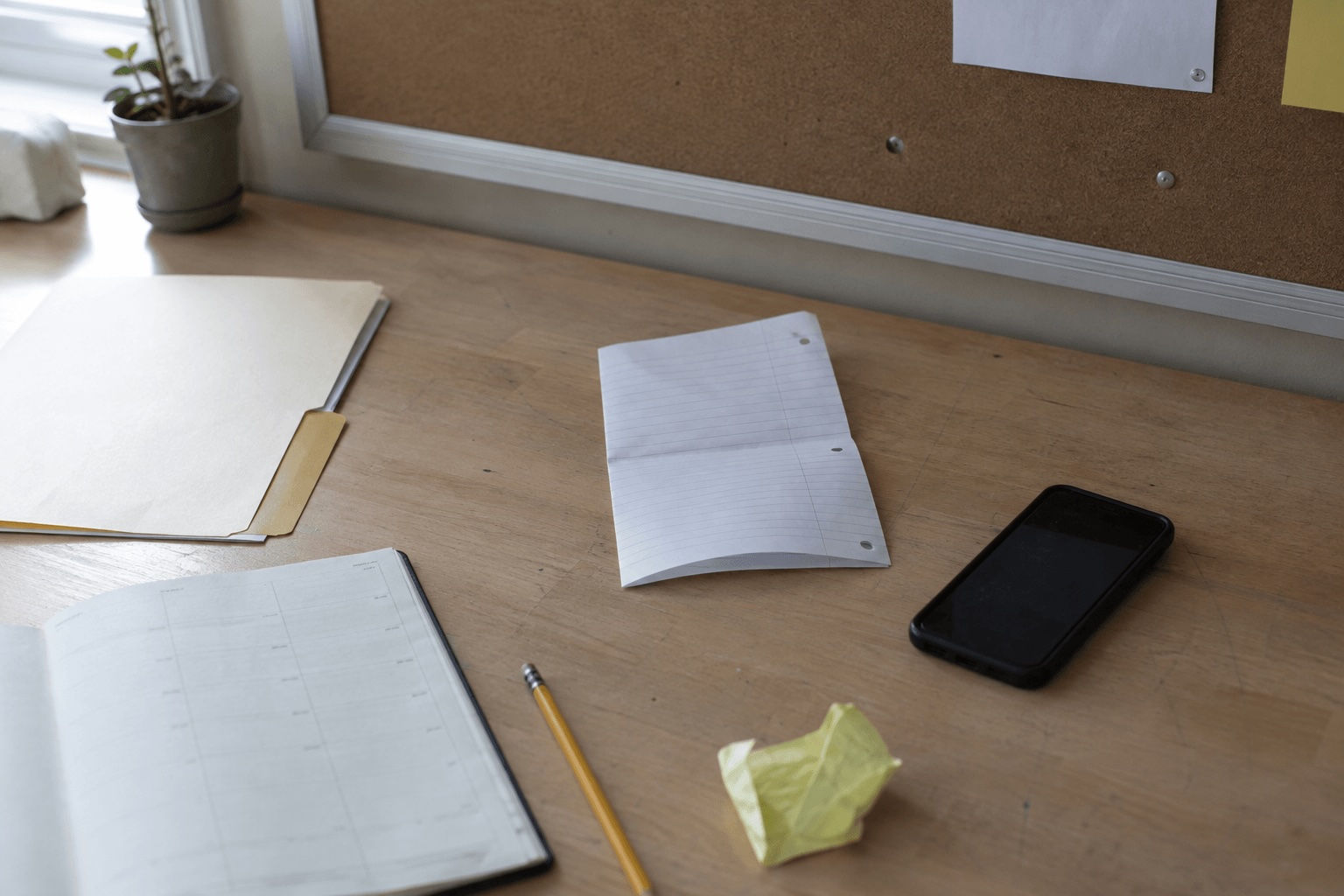 Scattered notes and documents on a desk.