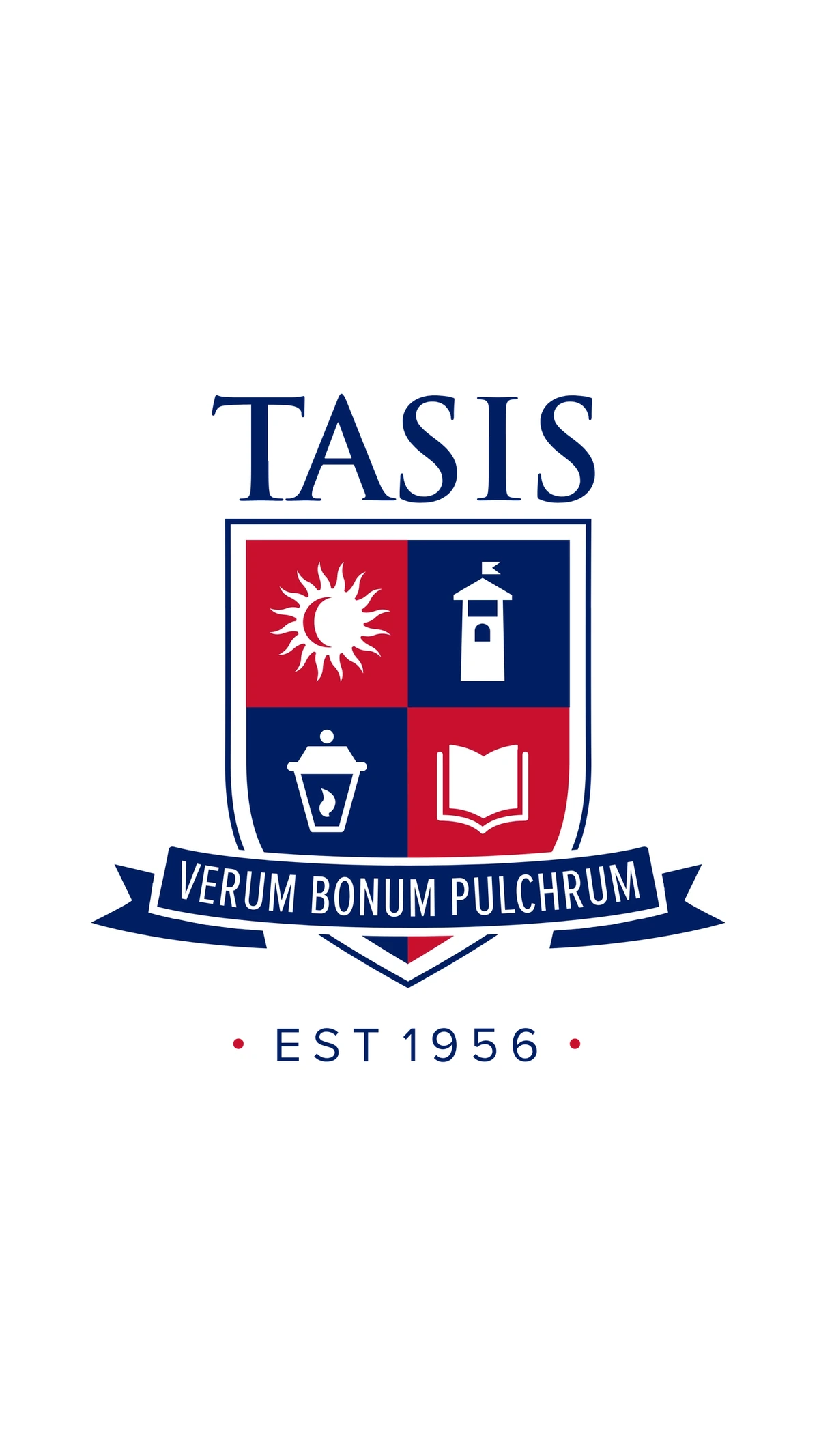 TASIS crest: a shield with a sun, a tower, a lantern and an open book, above a ribbon reading Verum Bonum Pulchrum and the words Est 1956.