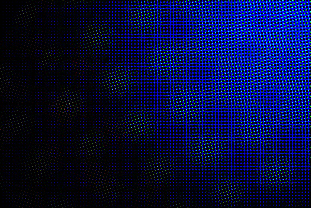 Blue and black circular pixel pattern with a halftone effect fading to black on the left.
