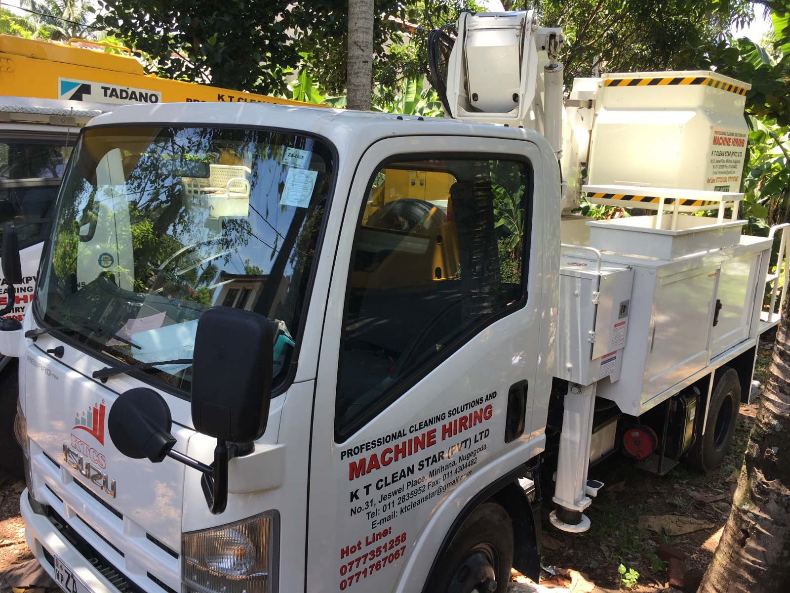 White machine hiring truck with equipment for professional cleaning and contact info on door.