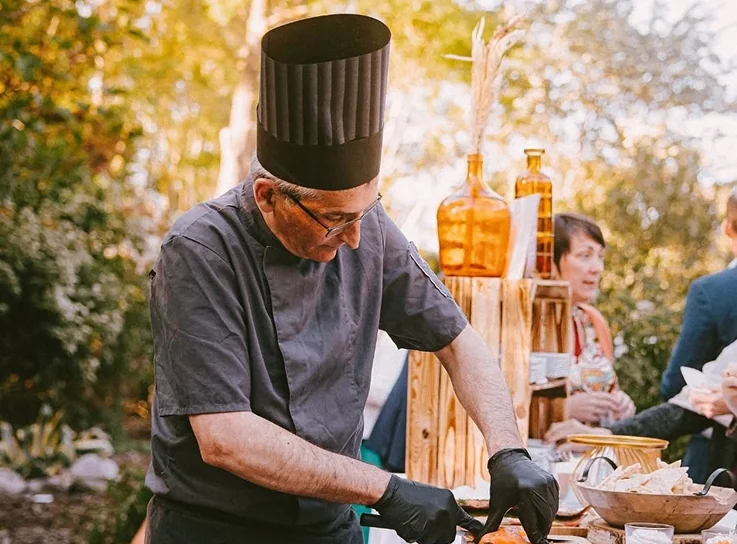 Chef de Skandi & Pergo tranchant du saumon lors d'une animation culinaire en extérieur