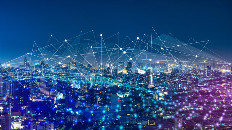 Digital network connections illustrated across a city skyline at night