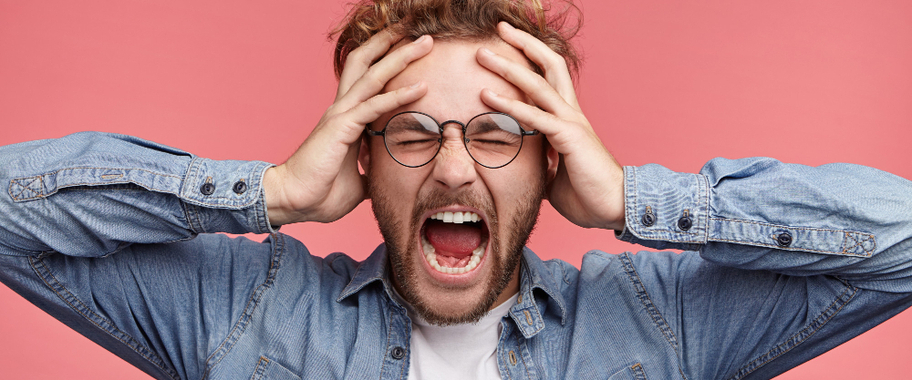 a man with his hands on his head, screaming