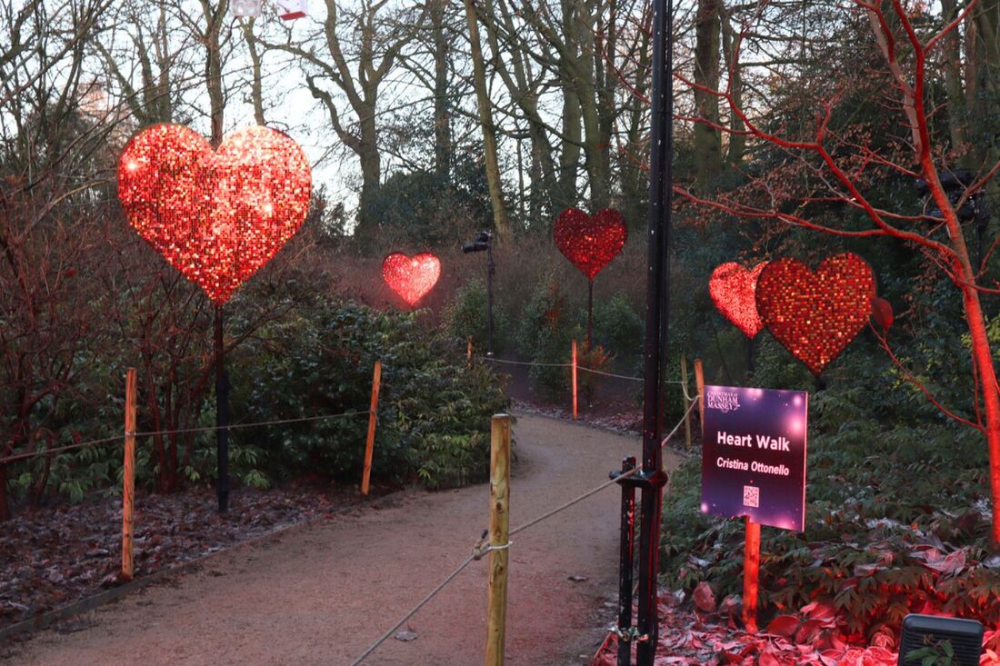 red sequin panel hearts on poles in woods