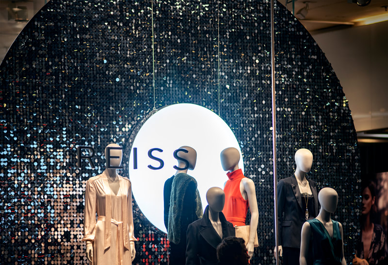 A large round sequin wall populated with black sequins.