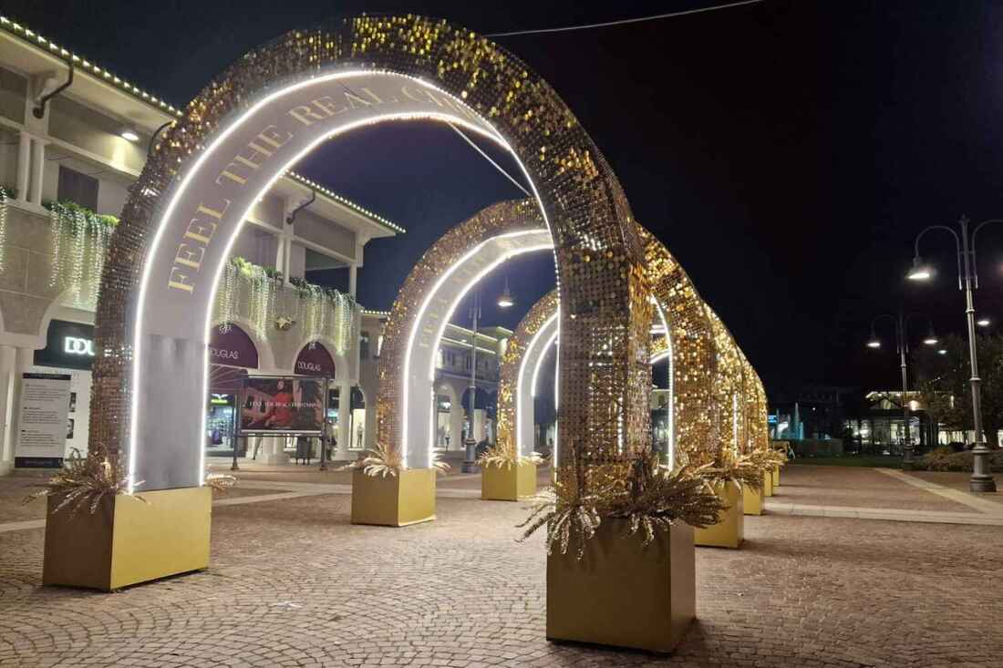 gold sequin arches at night
