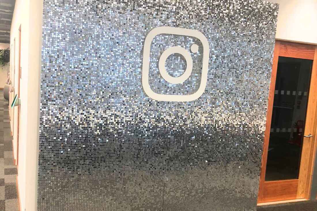 silver sequin backdrop with brand logo