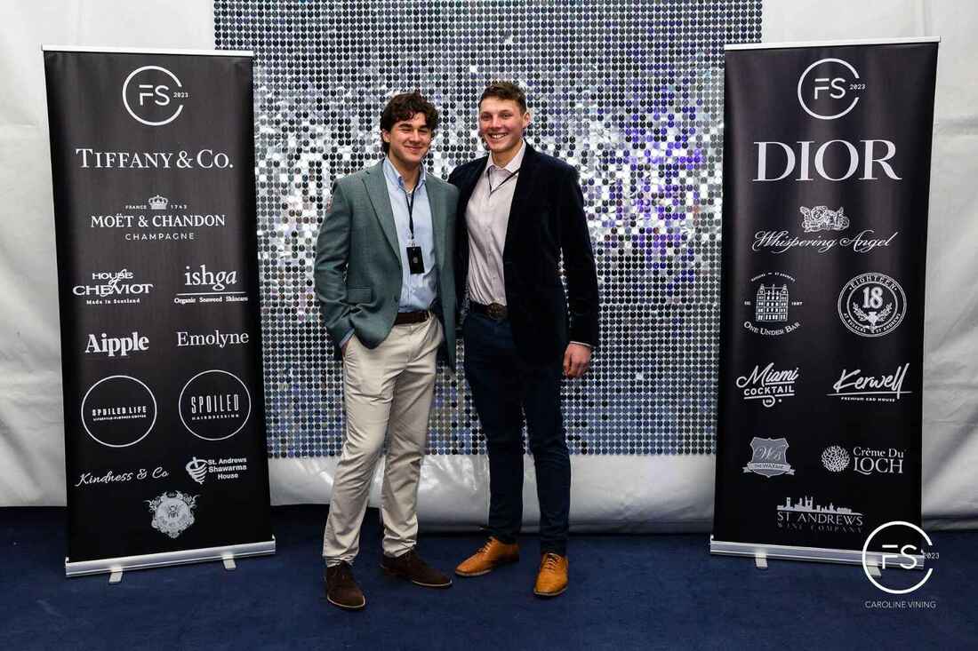 Men in front of silver shimmerwall