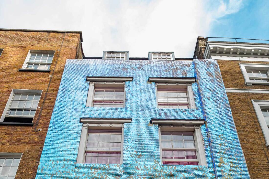 iridescent blue and pink sequin facade on a building