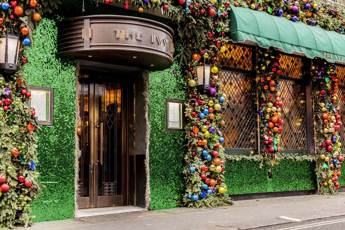 green sequins on exterior walls of restaurant, garland and ornaments framing edges
