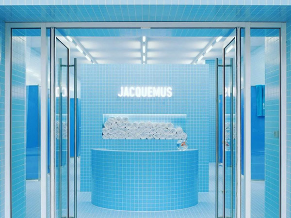 A summer-themed shop window display for a luxury fashion brand.