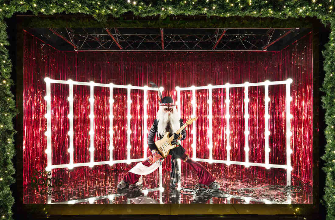 Red foil curtains with a rock n roll santa in front