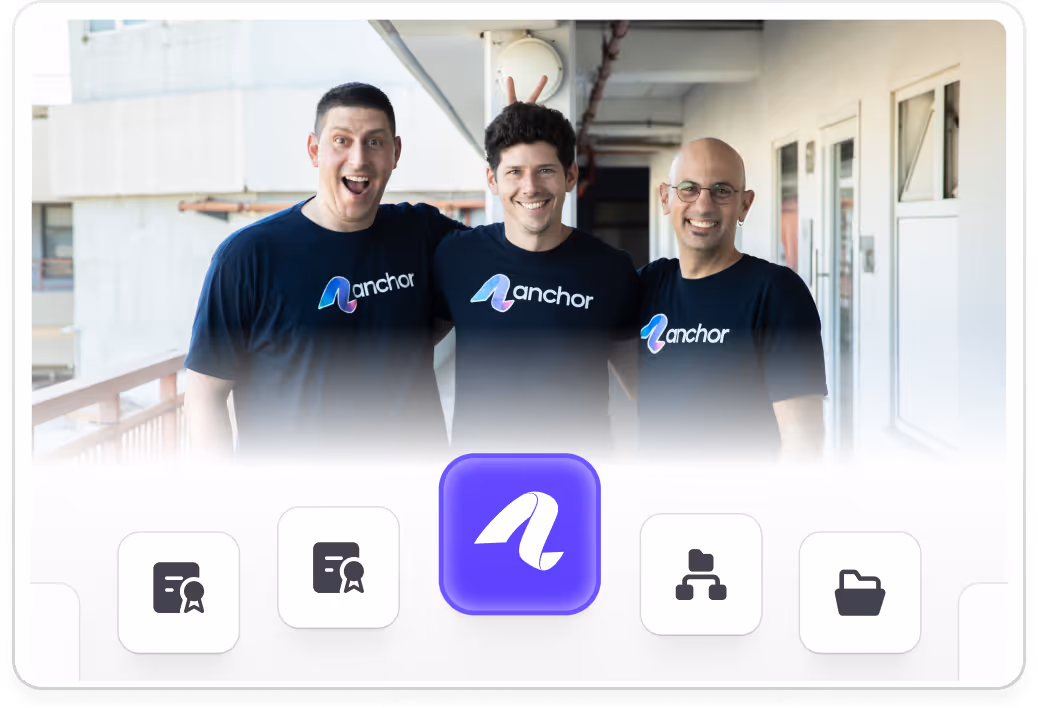 Three men wearing Anchor-branded shirts smiling, one playfully making bunny ears behind another.