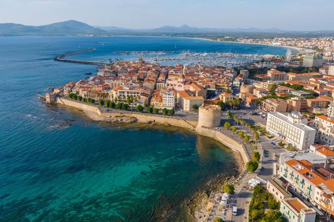The sea walls of Alghero's old town at sunset