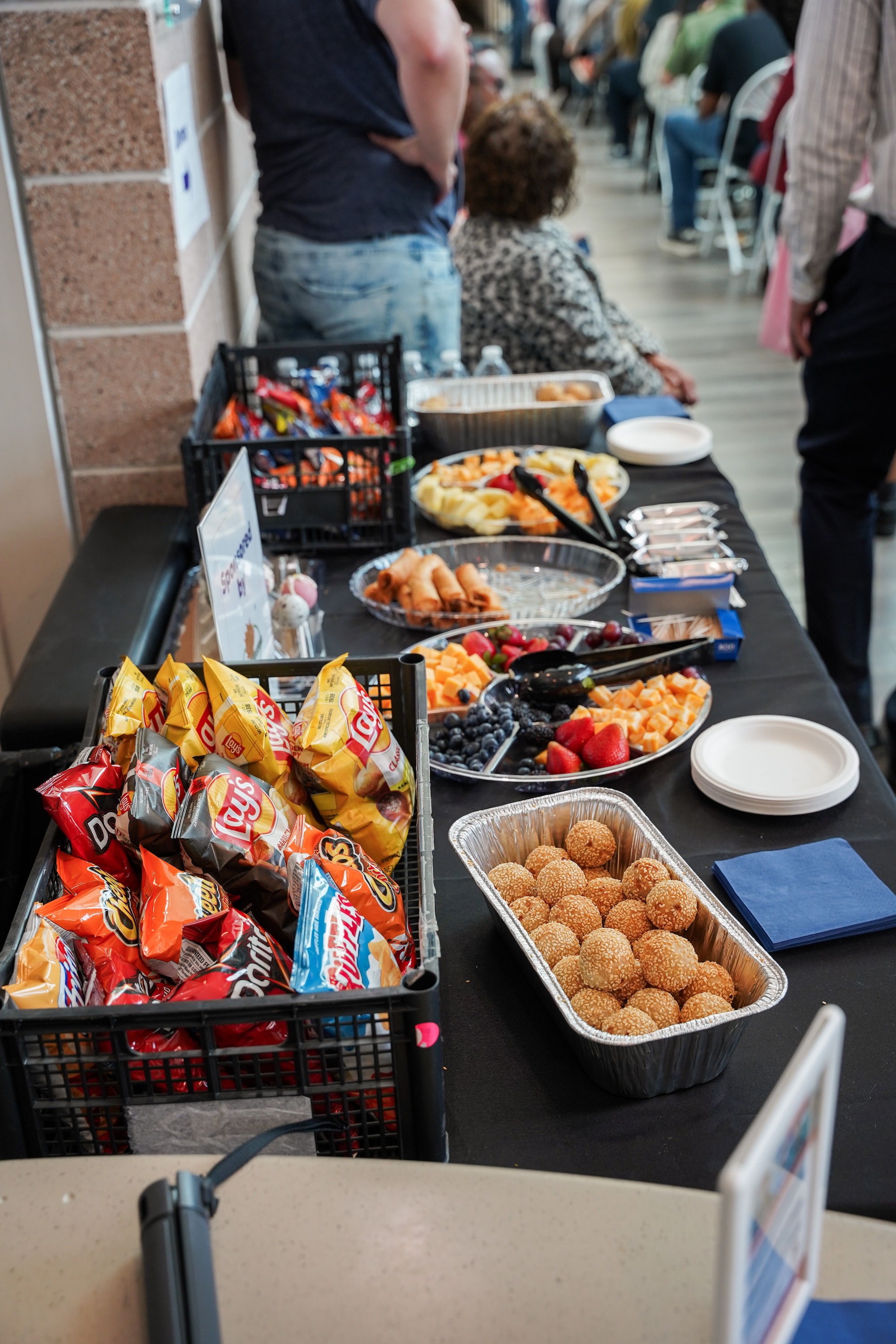image capturing a creative, interactive exhibit at a humanitarian aid fundraising event, emphasizing modern engagement