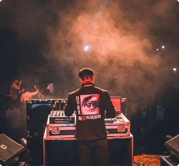 DJ performing on smoky stage